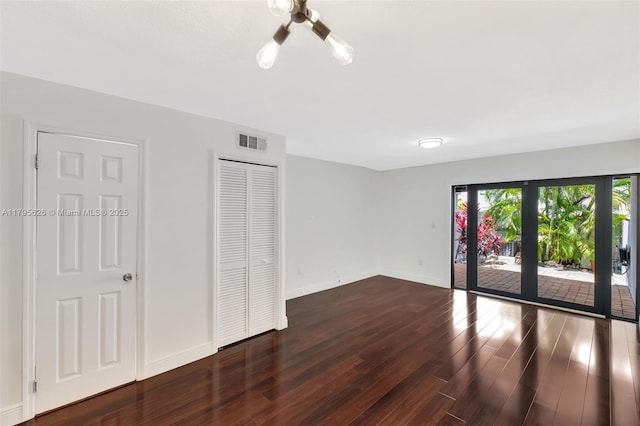 1901 NW S River Dr Unit 14-B, Miami, FL 33125 - unfurnished bedroom featuring wood finished floors, access to exterior, baseboards, and a closet