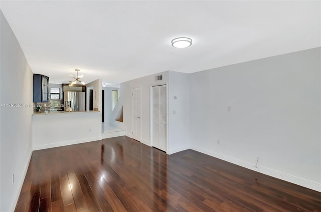 1901 NW S River Dr Unit 14-B, Miami, FL 33125 - unfurnished living room with a chandelier, dark wood-style floors, and baseboards