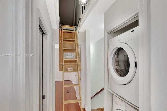 1901 NW S River Dr Unit 14-B, Miami, FL 33125 - laundry area featuring estacked washer and dryer and light wood-style flooring