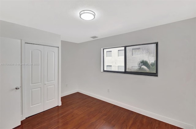 1901 NW S River Dr Unit 14-B, Miami, FL 33125 - unfurnished bedroom featuring wood finished floors, baseboards, and a closet
