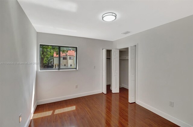1901 NW S River Dr Unit 14-B, Miami, FL 33125 - unfurnished bedroom featuring baseboards, wood finished floors, and a closet