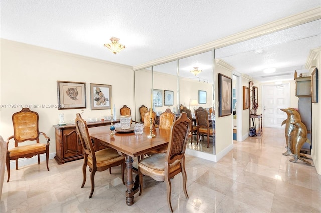 dining room with crown molding, marble finish floor, a textured ceiling, and baseboards