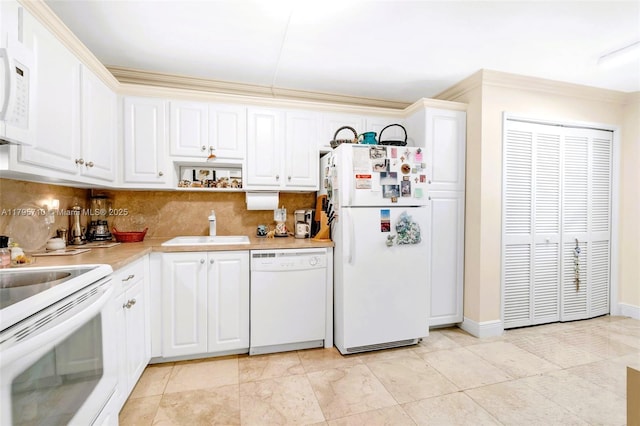 kitchen featuring tasteful backsplash, a sink, light countertops, white appliances, and white cabinetry