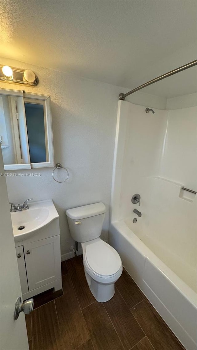 5156 NE 6th Ave Unit 205, Oakland Park, FL 33334 - bathroom featuring wood finished floors, toilet, vanity, and shower / tub combination