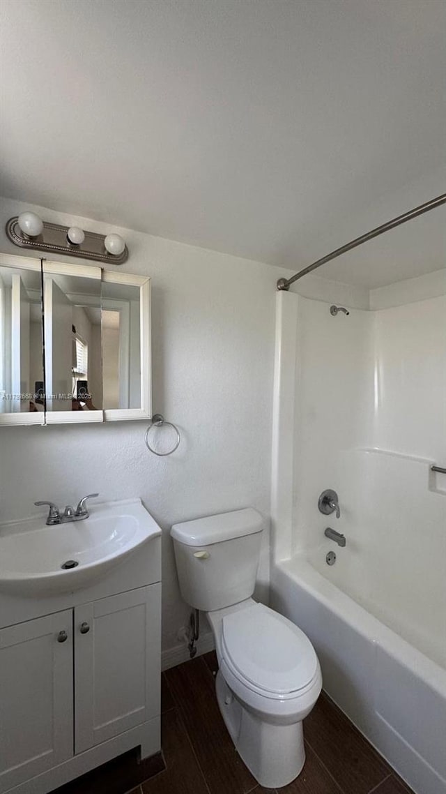 5156 NE 6th Ave Unit 205, Oakland Park, FL 33334 - full bath with toilet, wood finished floors, vanity, and shower / bath combination