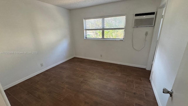 5156 NE 6th Ave Unit 205, Oakland Park, FL 33334 - unfurnished bedroom featuring baseboards, a textured ceiling, and dark wood-style floors