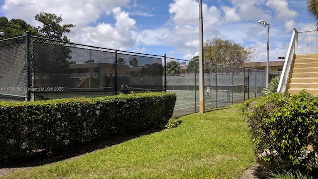 view of tennis court with stairs