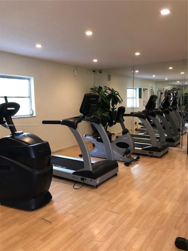 gym with plenty of natural light, wood finished floors, and recessed lighting