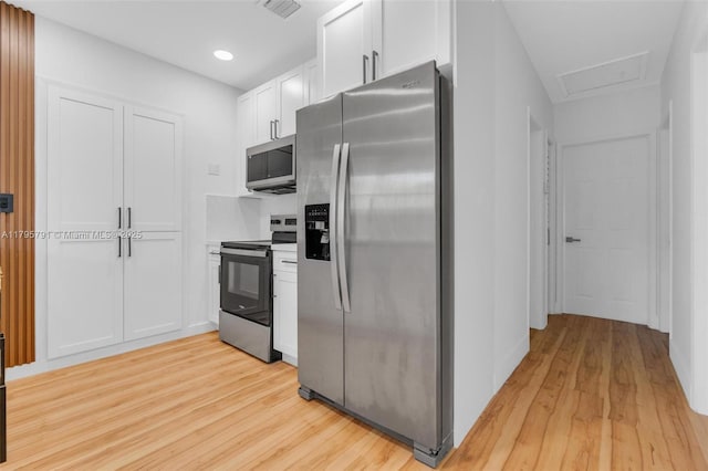 kitchen with visible vents, recessed lighting, white cabinets, light wood finished floors, and stainless steel appliances