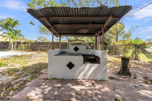view of patio featuring exterior kitchen and a fenced backyard