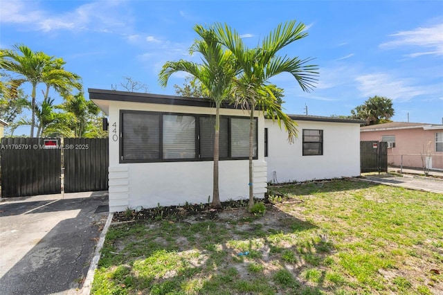 view of front of home featuring fence and stucco siding