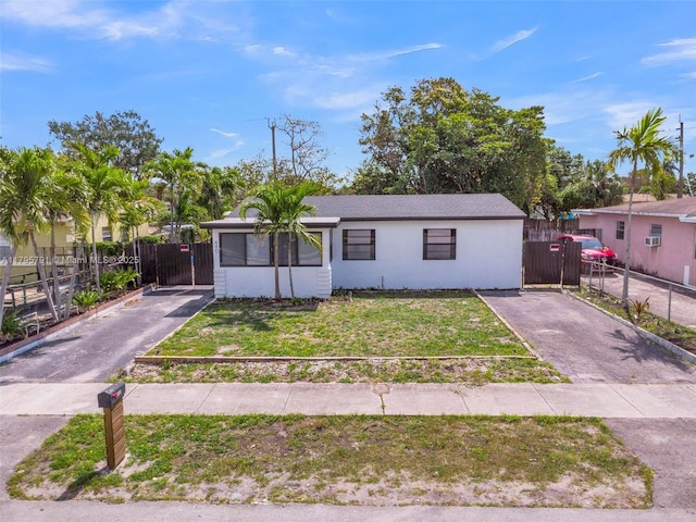 view of front of property with a front lawn, fence, and driveway