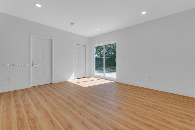 spare room featuring recessed lighting, baseboards, and light wood-style flooring
