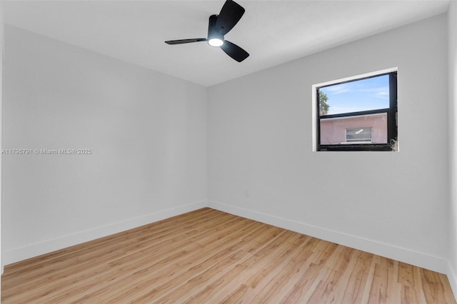 spare room with a ceiling fan, baseboards, and wood finished floors
