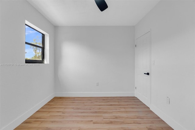 unfurnished room with baseboards and light wood finished floors