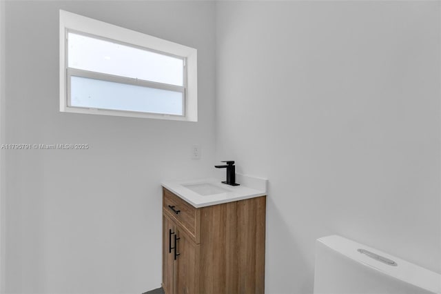 bathroom with toilet and vanity