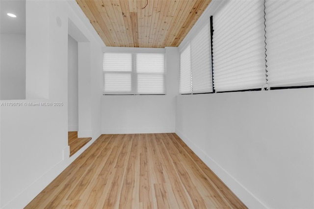 empty room with wood ceiling, baseboards, recessed lighting, and wood finished floors