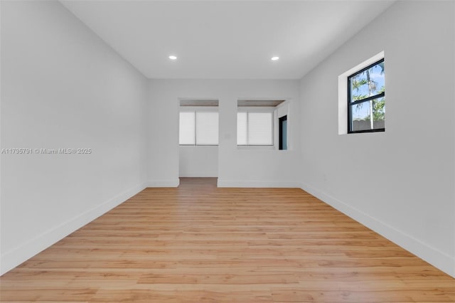 spare room featuring recessed lighting, baseboards, and light wood-type flooring
