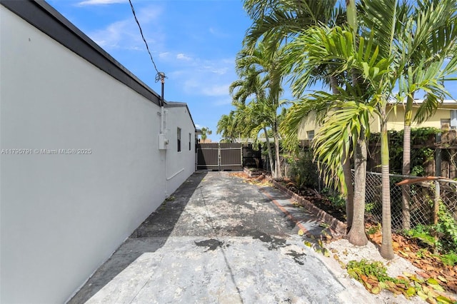 view of property exterior featuring fence, a patio area, and stucco siding
