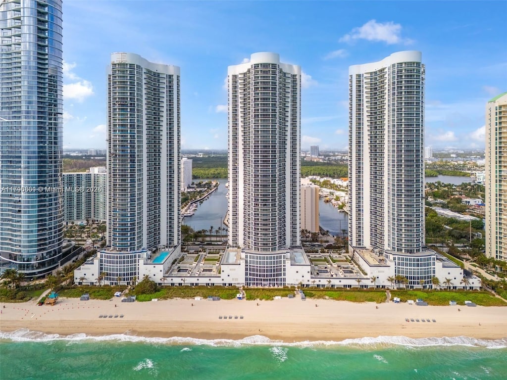 property's view of city with a water view and a view of the beach