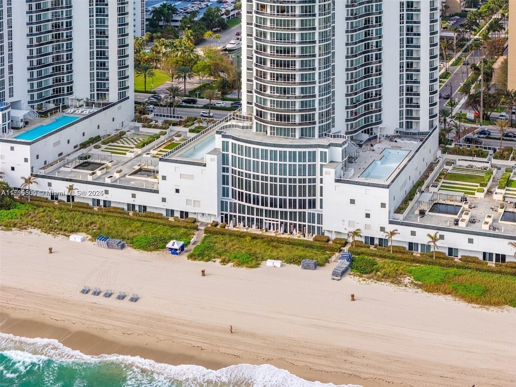 bird's eye view featuring a water view and a view of the beach