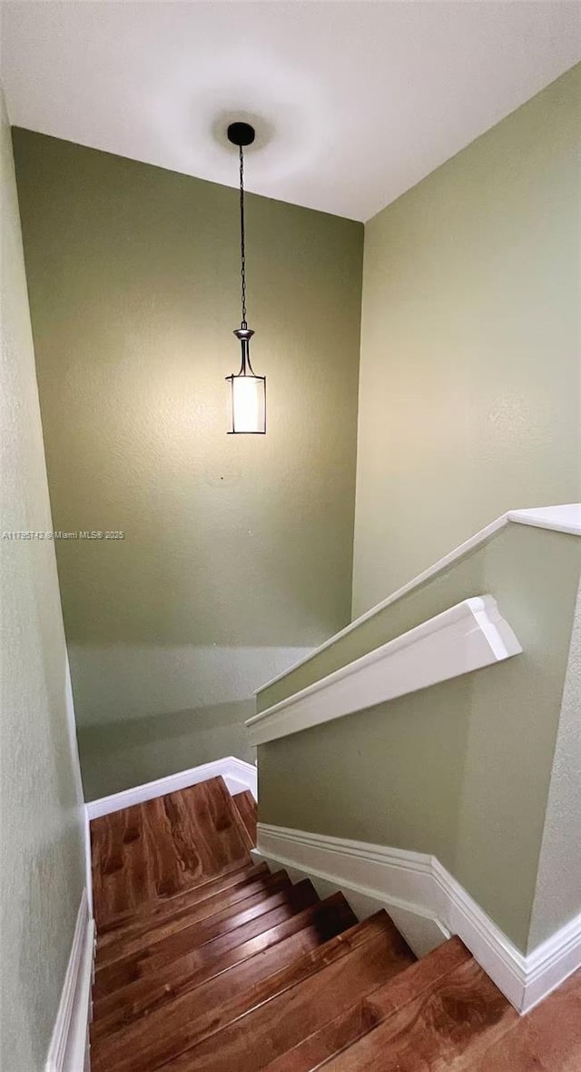 stairs with baseboards and wood finished floors