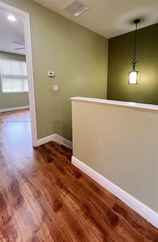 interior space featuring baseboards, visible vents, and dark wood-type flooring