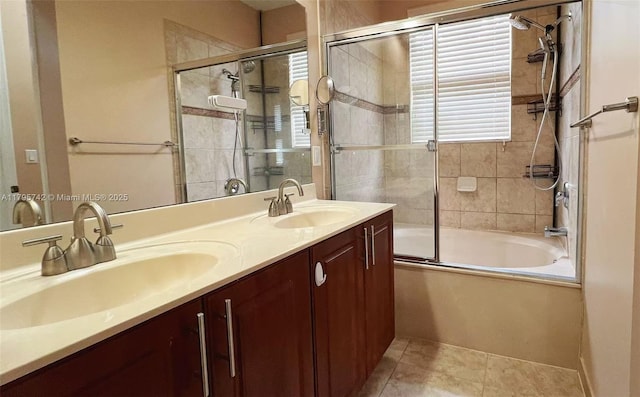 full bath with double vanity, a sink, tile patterned flooring, and shower / bath combination with glass door