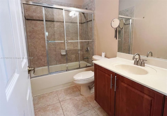 full bathroom with tile patterned floors, vanity, toilet, and shower / bath combination with glass door