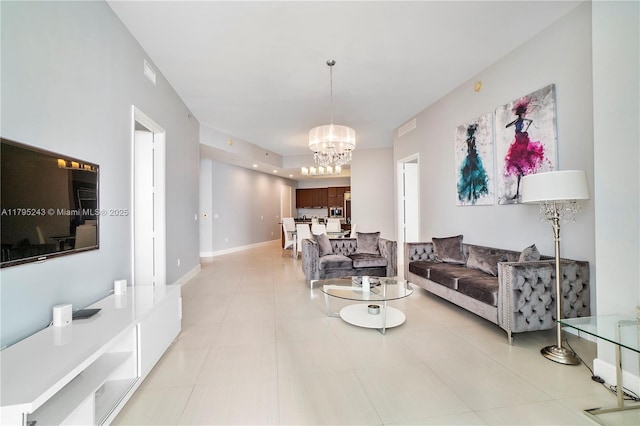 living area featuring a notable chandelier and light tile patterned floors