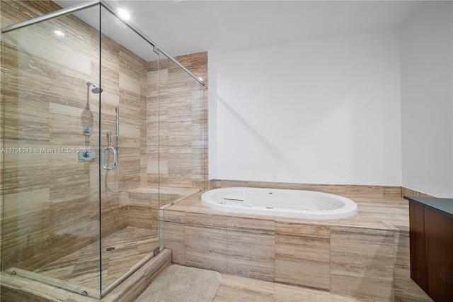 bathroom featuring a garden tub and a stall shower