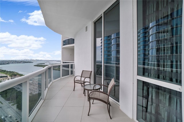 balcony with a water view and visible vents