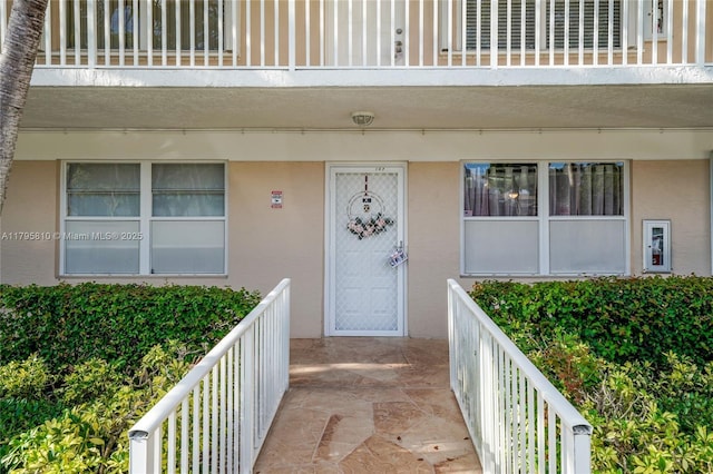 10217 NW 24th Pl Unit 107, Sunrise, FL 33322 - property entrance featuring stucco siding and a balcony