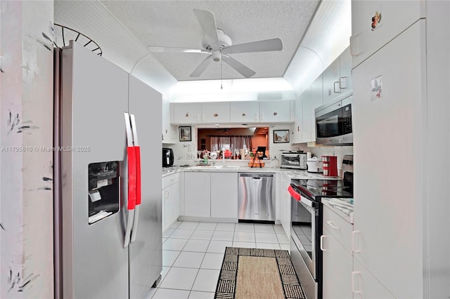 10217 NW 24th Pl Unit 107, Sunrise, FL 33322 - kitchen featuring appliances with stainless steel finishes, ceiling fan, light tile patterned flooring, light countertops, and a textured ceiling