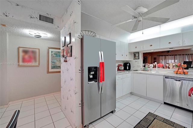 10217 NW 24th Pl Unit 107, Sunrise, FL 33322 - kitchen featuring appliances with stainless steel finishes, a textured ceiling, a ceiling fan, light countertops, and light tile patterned floors