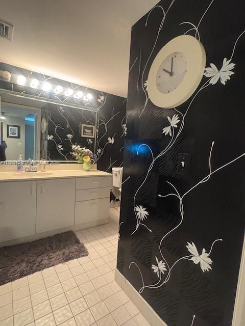 bathroom featuring tile patterned flooring, vanity, and visible vents