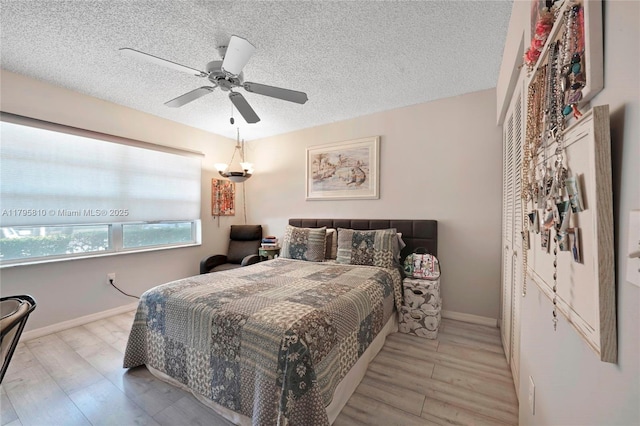 10217 NW 24th Pl Unit 107, Sunrise, FL 33322 - bedroom with wood finished floors, a ceiling fan, and a textured ceiling
