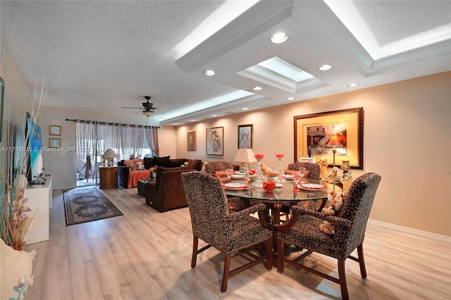 10217 NW 24th Pl Unit 107, Sunrise, FL 33322 - dining area with light wood finished floors, recessed lighting, ceiling fan, a tray ceiling, and a textured ceiling