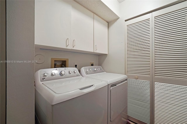 laundry area with cabinet space, independent washer and dryer, and a heating unit
