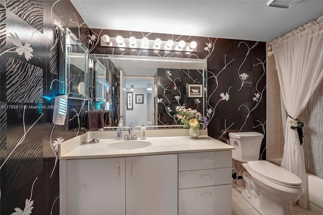 bathroom featuring toilet, vanity, and tile patterned flooring