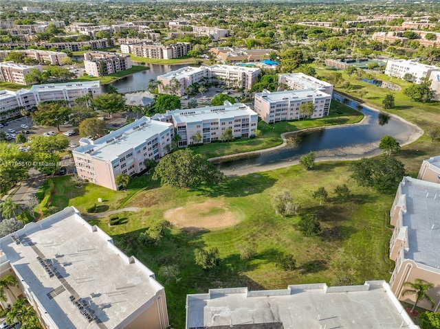 view of urban area featuring apartment complex and a large body of water