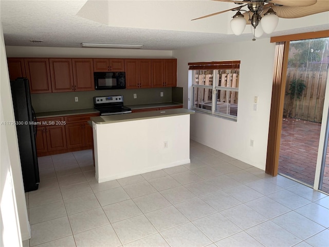kitchen featuring brown cabinets, a textured ceiling, a ceiling fan, light tile patterned floors, and black appliances