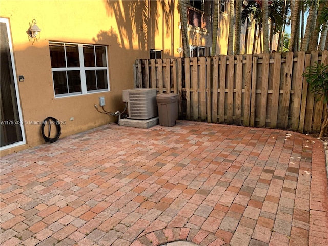 view of patio / terrace with fence and central air condition unit