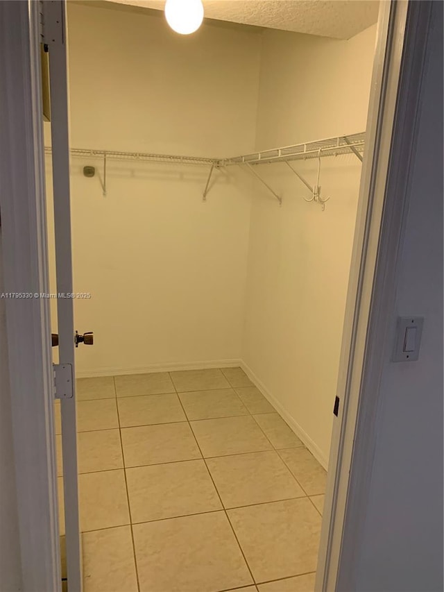 walk in closet featuring light tile patterned floors