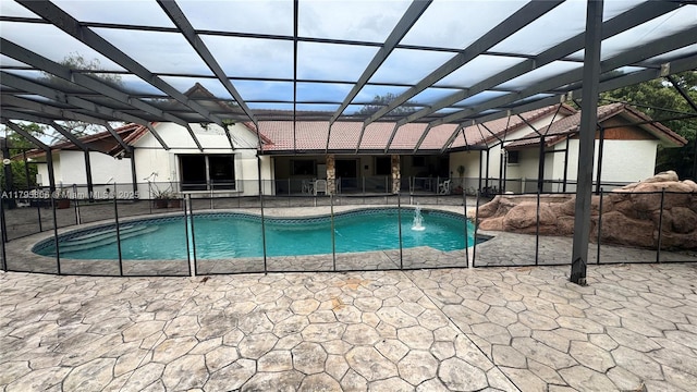 pool with a patio and glass enclosure