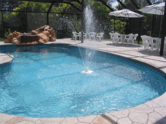 outdoor pool featuring a lanai and a patio area
