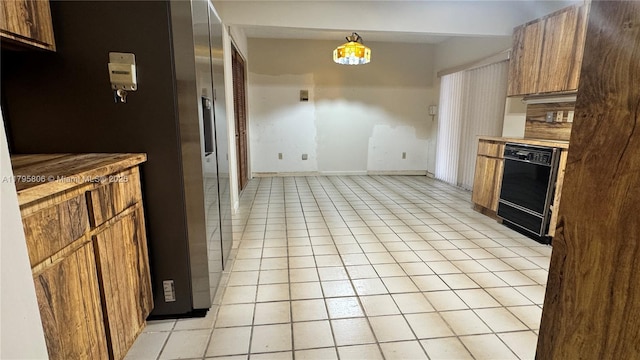 kitchen with brown cabinets, dishwasher, light countertops, baseboards, and light tile patterned flooring