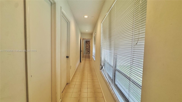 corridor featuring light tile patterned floors and recessed lighting
