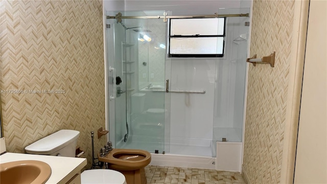 full bath with vanity, a stall shower, toilet, and wallpapered walls