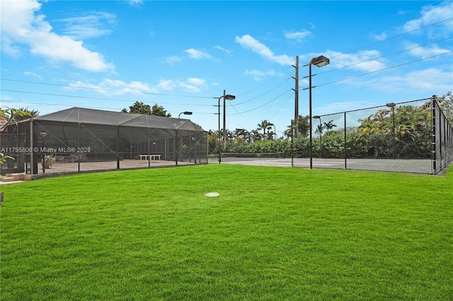 exterior space featuring a tennis court and fence